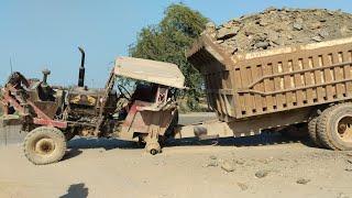 Lifting up heavy accident tractor trolley with caterpillar wheel loader