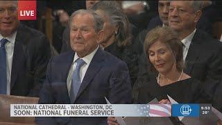 Former President Bush sits with other  living presidents at Jimmy Carter's funeral at National Cathe