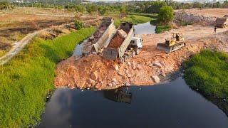 Really Great! Excellent Operator Bulldozer Pushing Stone Building New Road Crossing the Canal