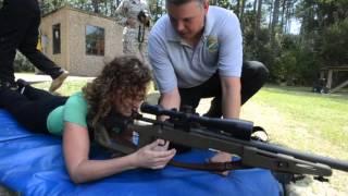 Northwest Florida Daily News military reporter Lauren Reinlie tries out sniper rifle