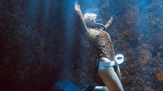 Sunlights on the Freediving Girl in a Cave