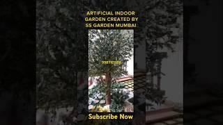 Artificial Garden Created with Faux Plants Tree, Grass, Wooden Footsteps, Marble Stones