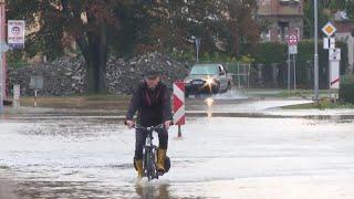 Vehicles drive through water as streets flooded in Litovel, Czech Republic