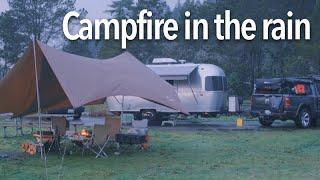 Camping in the rain under a fire-resistant tarp from Snow Peak