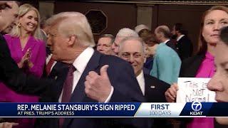 Rep Stansbury holds protest sign before President Trump's address to Congress