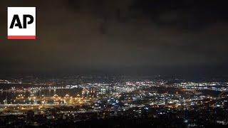 Security personnel clear rubble after sirens and blasts heard in Haifa