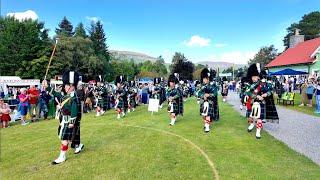 Drum Major leads Huntly Pipe Band playing on march in during 2024 Braemar Gathering in Scotland