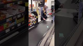 Cashier is waiting on tictacs to go all the way down the conveyor belt.