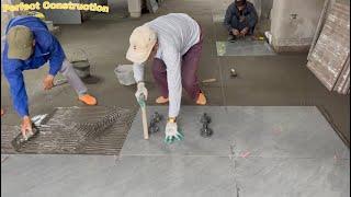 Construction And Installation Of Luxurious Ceramic Tiles For The Living Room Floor Using A Vibrator