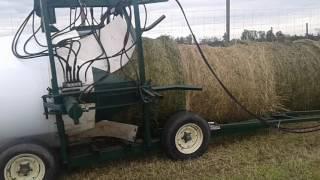 Silage bales loaded into tube-o-lator plastic bag