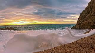 Majestic Sunrise Amidst Strong Waves and White Foam