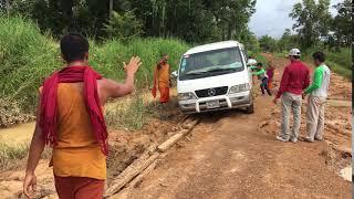 Transportation van on dirty road with monks's help