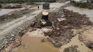 Stunning View New Road Building Technology Over Water and forest Bulldozer Spreading Stone and Soil