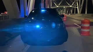 Unmarked vehicle blocking lanes on bridge