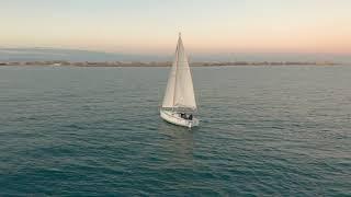 videoblocks aerial view the yacht sails on the sea at sunset drone flies around the yacht with sails