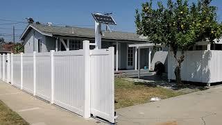 white vinyl privacy Rollin gate motorized and powered by solar