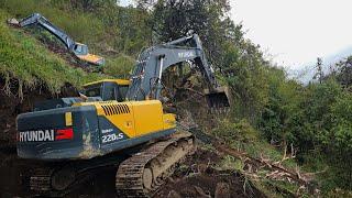 Expert Operator Building Narrow Mountain Road: Hyundai Excavator Expertly Clears Stones and Trees