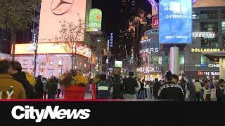 Chaotic scene at Yonge and Dundas as fireworks and vehicles flood the intersection