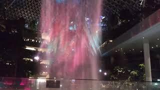 Train inside building + light show. Changi Jewel waterfall with airport train.