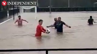 Footballers turn flooded Gloucestershire pitch into swimming pool