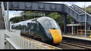 Variety of trains speeding through Ealing Broadway