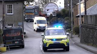 Police escort large drilling machine passed oversize house in Welsh village