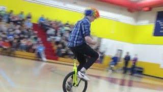 Isaac solving a Rubik's Cube on a unicycle (Talent Show)