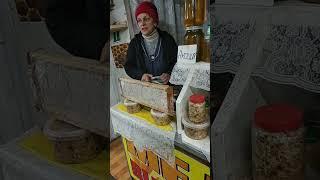 honey seller at market, kyiv , ukraine, December 11, 2022