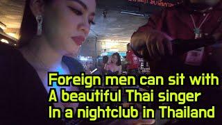 The privilege of a foreign man at a club in Thailand, you can sit with a beautiful female singer