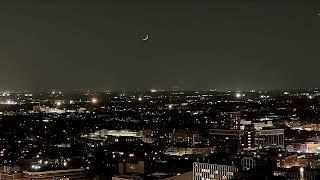 Nascent Strawberry Moon setting over Chicago with O'Hare traffic in foreground.