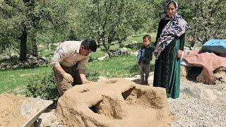 Hardworking hands of nomads: and building a traditional fireplace for cooking in the heart of nature
