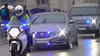 Metropolitan Police Special Escort Group escorting cars in heavy rain