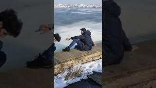 Scrawny kid falls in frozen lake