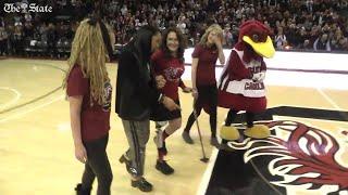 Shawn Kiser walks with USC Coach Dawn Staley after boating accident