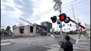 Metro Trains pass railroad crossing on Stewart street