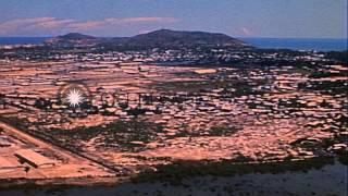 An aircraft flies over and lands at the Vung Tau air base in Vietnam HD Stock Footage