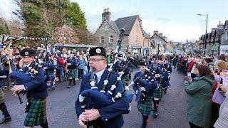 Vale of Atholl Pipe Band march off back into Hotel during Pitlochry New Year 2025 Street Party