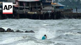 Floods in Philippines kill at least 9 and trap others on roofs