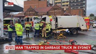 Emergency operation underway to free man trapped in garbage truck in Sydney