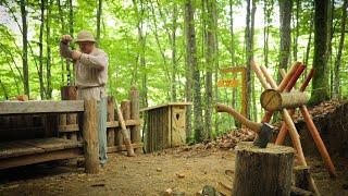 Solo bushcraft in the forest. Log house