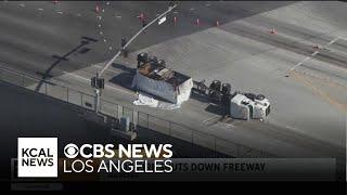 A big-rig on fire continues to burn Friday morning on the roadway near the Port of Los Angeles