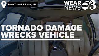 Inside car perspective shows Florida tornado debris severely damage vehicle