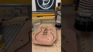 Pocketing, outline, and top carving of Dunham Guitars Artisan Guitar in curly redwood