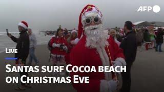 LIVE: Surfing Santas ride waves at Cocoa Beach on Christmas Eve I AFP