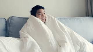 little asian boy watching tv on sofa