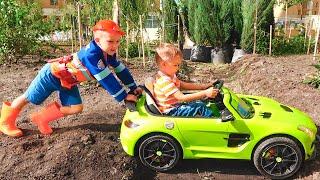 Niki ride on children's car and stuck in the ground Vlad tows on the tractor