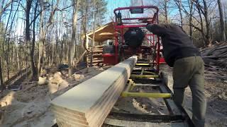 Logs from Andrew Camarata turned into boards for a building