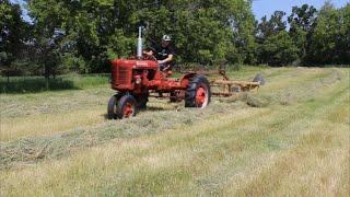 Farmall B raking hay