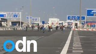 Calais migrants caught on video rushing to board a ferry