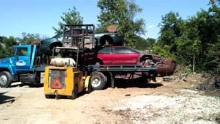 Car slides off other side of tow truck